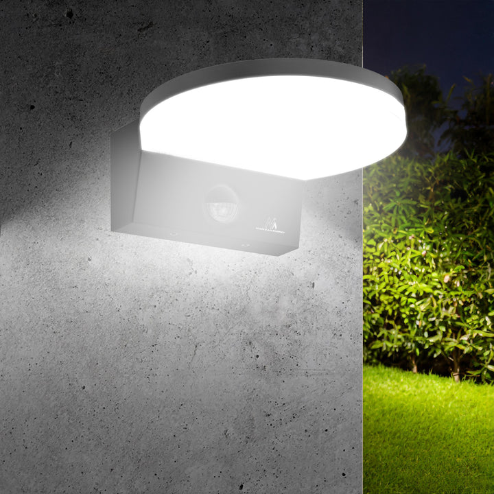 Maclean MCE344 B motion sensor LED lamp. With a PIR motion sensor, it emits neutral white light (4000K) with 15W power and 1560lm brightness. Rated IP65, it ensures durability and reliability in various settings.